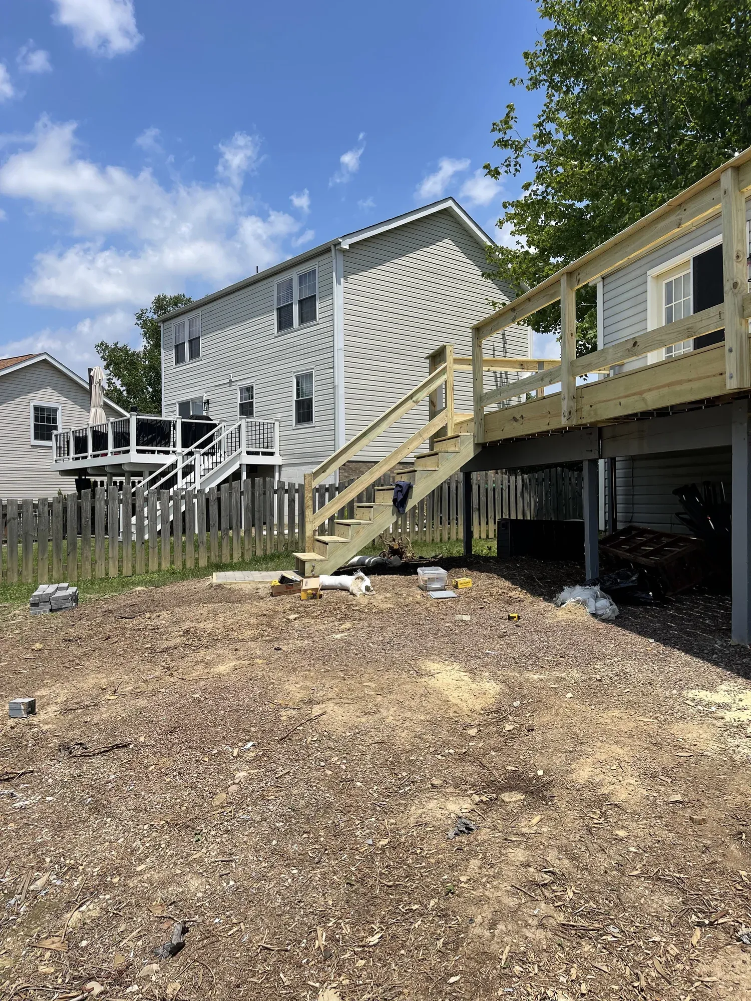 Rebuilt pressure-treated wood deck with newly framed railings