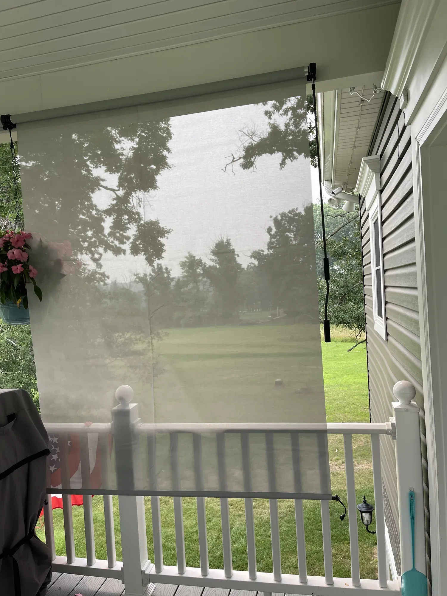 Roll-down privacy blind installed on a covered deck