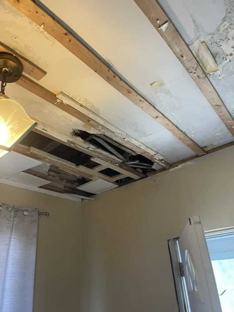 Water-damaged ceiling torn down before replacement