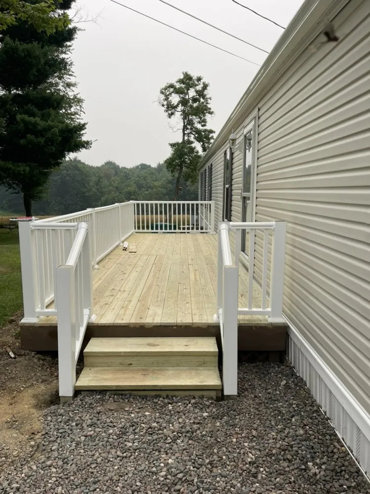 Completed wood deck with new white vinyl railings