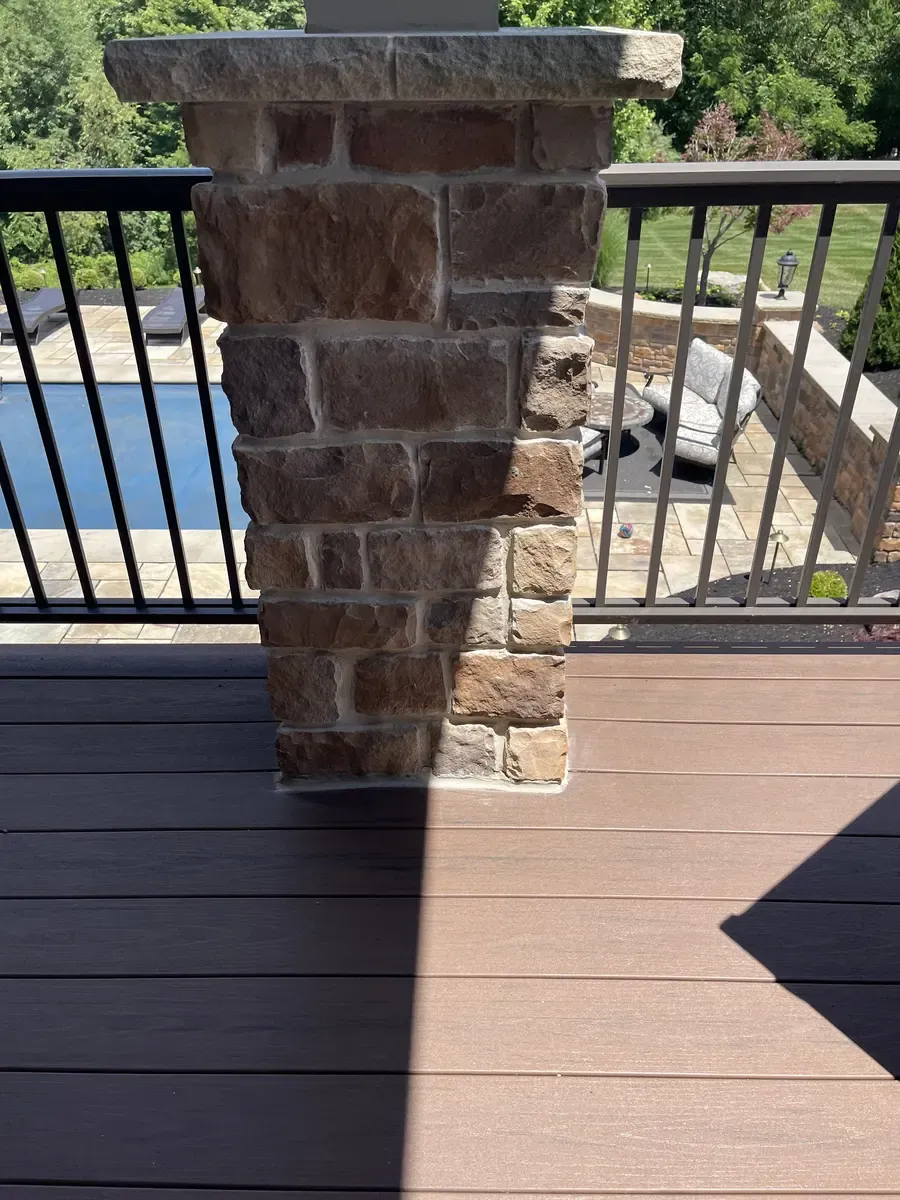 Finished concrete and mortar repairs on a stone deck column